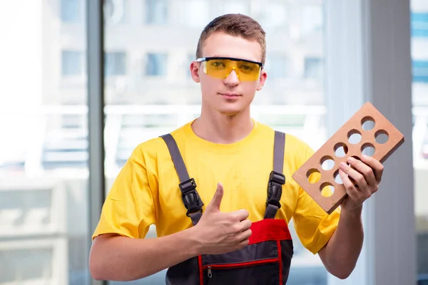 Young construction worker in yellow coveralls — Stock Photo, Image