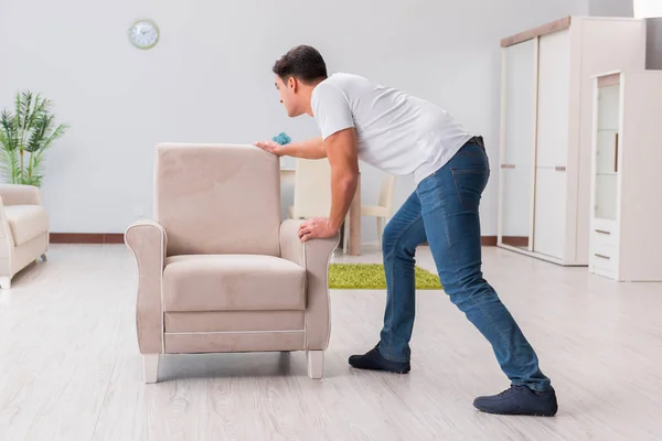 Man moving furniture at home — Stock Photo, Image