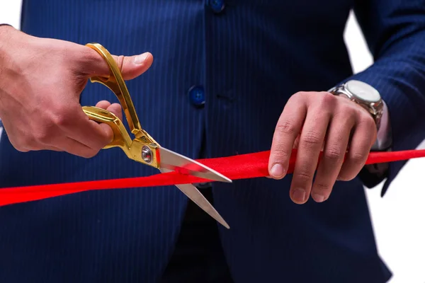 Businessman cutting red ribbon isolated on white — Stock Photo, Image