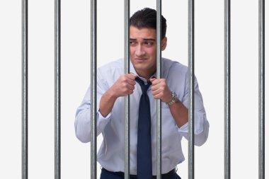 Young businessman behind the bars in prison clipart