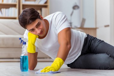 Koca adam evi temizliyor, karısına yardım ediyor.