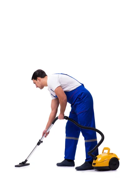 Man in coveralls doing vacuum cleaning on white — Stock Photo, Image