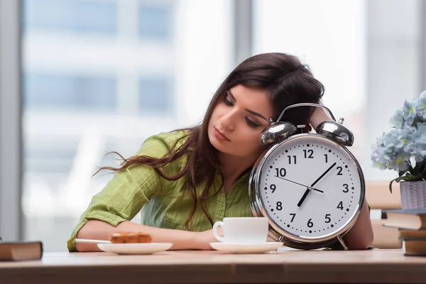 Student with gian alarm clock preparing for exams — Stock Photo, Image