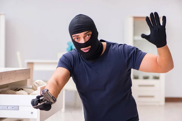 Robber wearing balaclava stealing valuable things — Stock Photo, Image