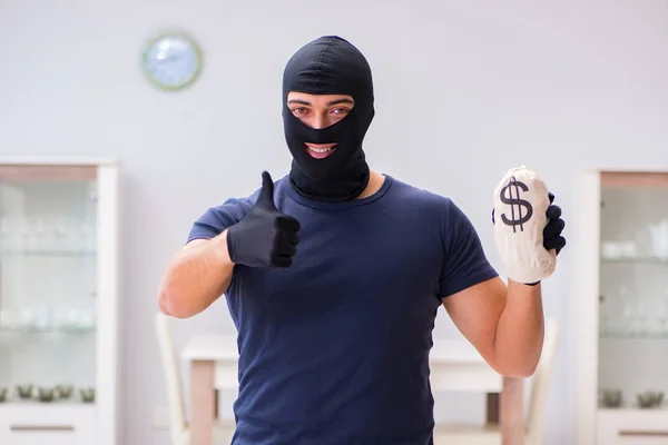 Robber wearing balaclava stealing valuable things — Stock Photo, Image