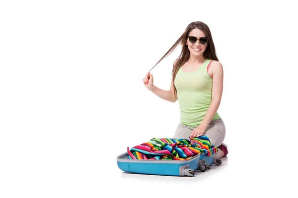 Young woman packing for summer vacation isolated on white — Stock Photo, Image