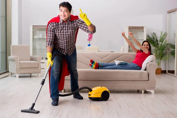 Marido super-herói ajudando sua esposa em casa — Fotografia de Stock