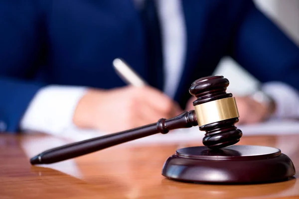 Handsome judge with gavel sitting in courtroom — Stock Photo, Image