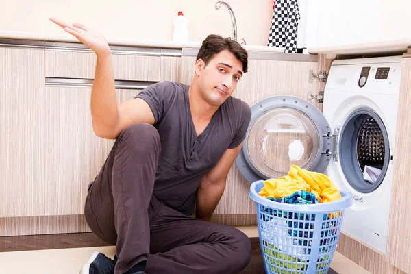 Jeune mari homme faisant la lessive à la maison — Photo