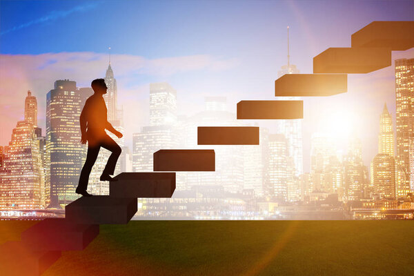 Businessman in career promotion concept with stairs