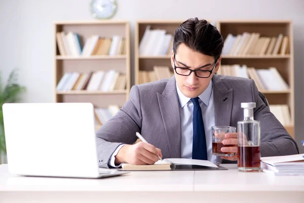 Young businessman drinking from stress — Stock Photo, Image