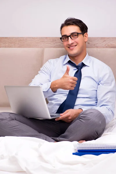 Businessman working in the bed at home — Stock Photo, Image