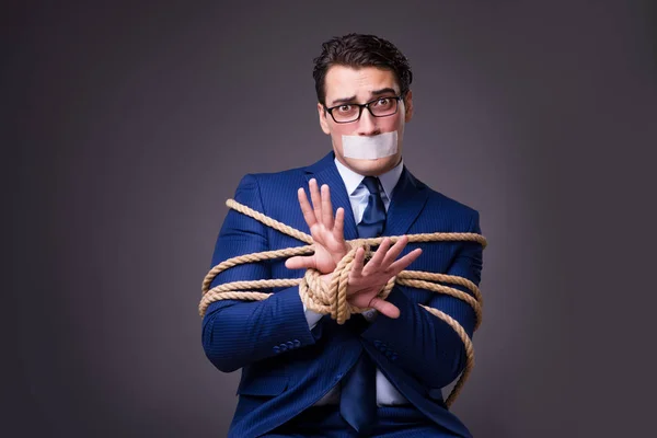 Businessman taken hostage and tied up with rope — Stock Photo, Image