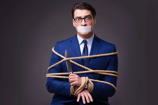 Businessman taken hostage and tied up with rope — Stock Photo, Image