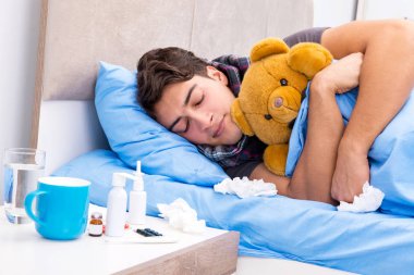 Sick man with flu lying in the bed clipart