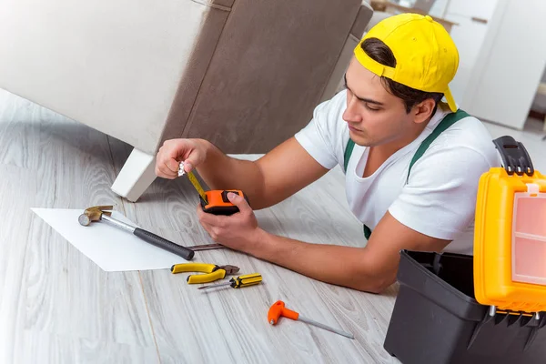 Worker repairing furniture at home