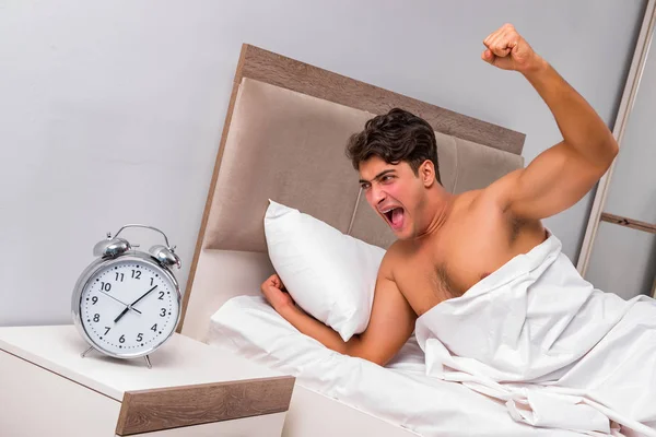 Man having trouble waking up in the morning