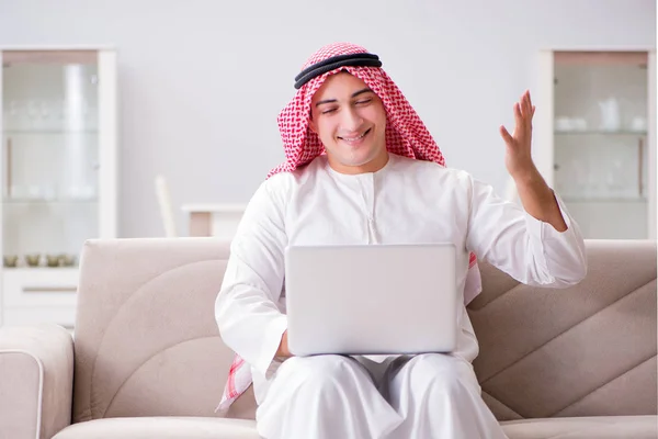 Young arab businessman working with laptop on sofa — Stock Photo, Image