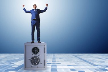 Businessman standing on top of safe clipart