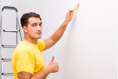 Duvarı DIY konseptiyle boyayan adam