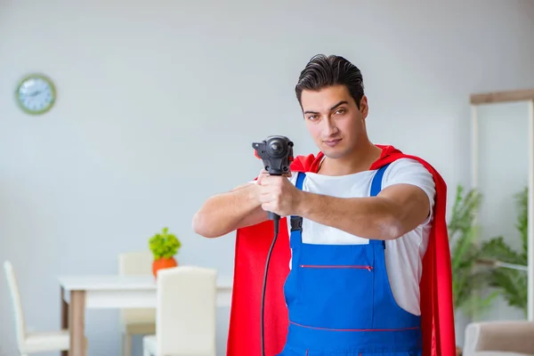 Super hero repairman working at home — Stock Photo, Image