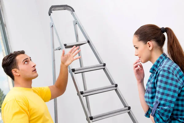 Young family painting the walls in DIY concept — Stock Photo, Image