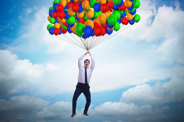 Businessman flying on balloons in challenge concept