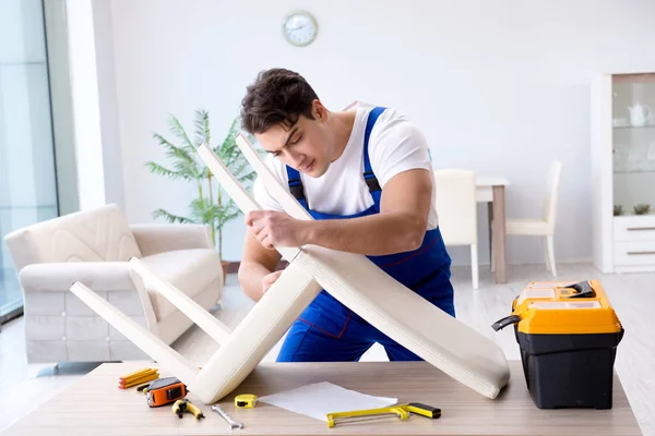 Man repairing chair in the room — Stock Photo, Image