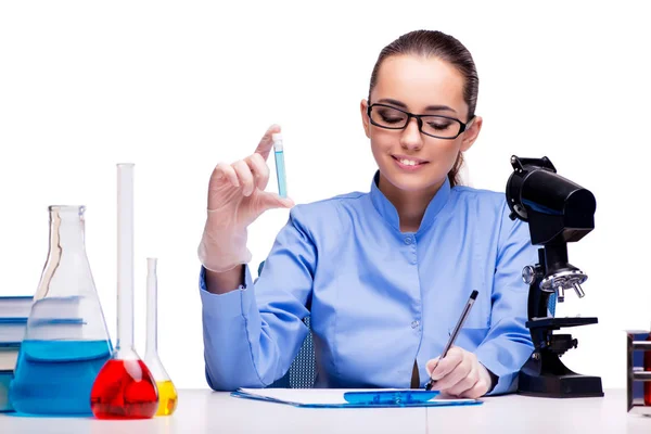 Lab chemist working with microscope and tubes Stock Photo
