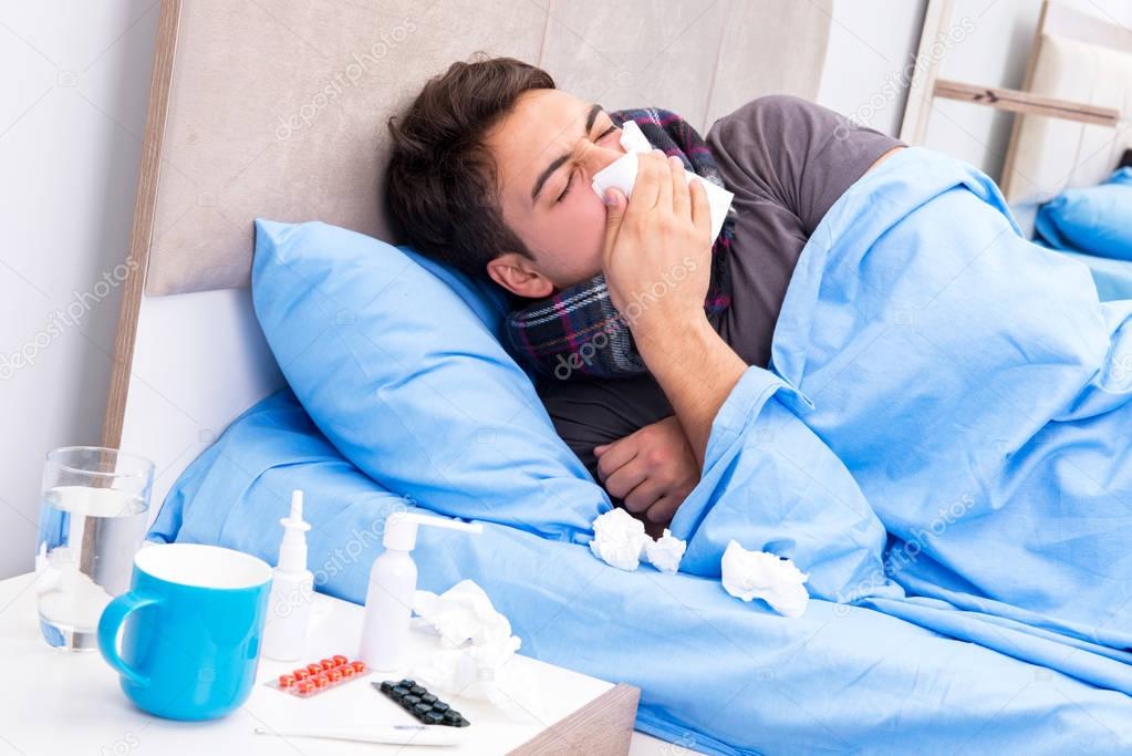 Sick man with flu lying in the bed