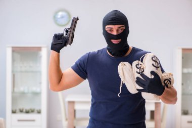 Soyguncu kar maskesi takıp değerli şeyler çalıyor.