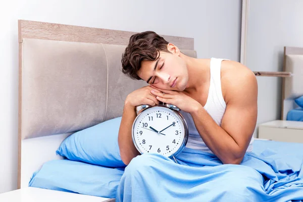 Man having trouble waking up in morning