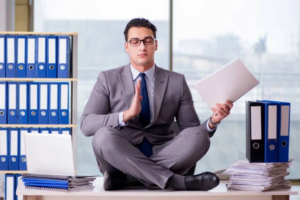 Businessman meditating in the office — Stock Photo, Image