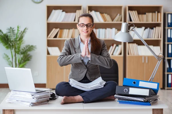 Businesswoman meditating in the office — Stock Photo, Image