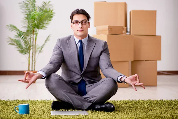 Businessman meditating on the office floor — Stock Photo, Image