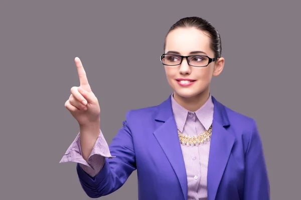 Businesswoman pressing virtual button on gray background — Stock Photo, Image