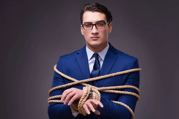 Businessman tied up with rope — Stock Photo, Image