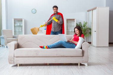 Süper kahraman koca karısına evde yardım ediyor.