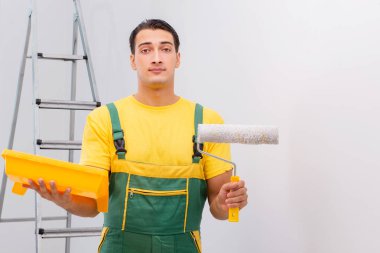 Duvarı DIY konseptiyle boyayan adam