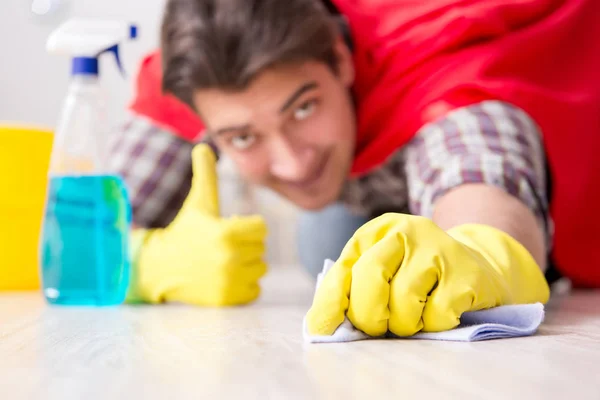 Super hero husband cleaning floor at home — Stock Photo, Image