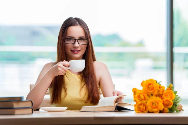 Young student drinking coffee while sudying — Stock Photo, Image