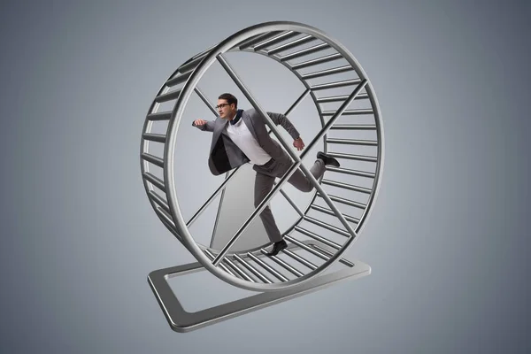 Businessman running on hamster wheel — Stock Photo, Image