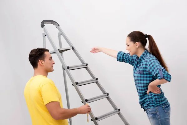 Young couple painting wall at home — Stock Photo, Image