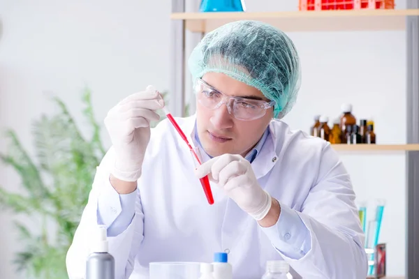 Blood testing in the lab with young scientist