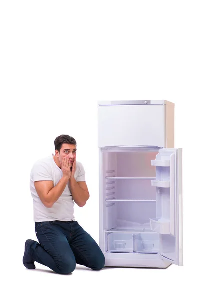 Man looking for food in empty fridge — Stock Photo, Image