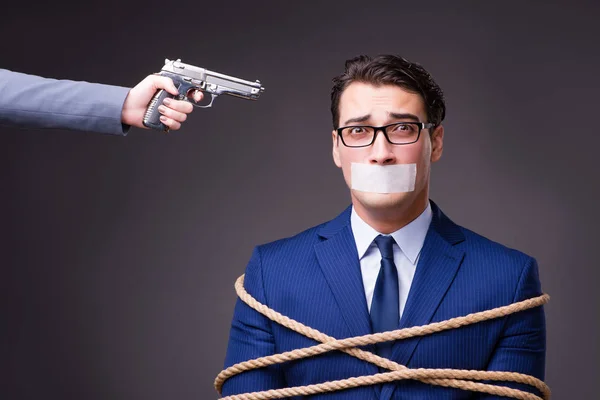 Businessman taken hostage and tied up with rope — Stock Photo, Image