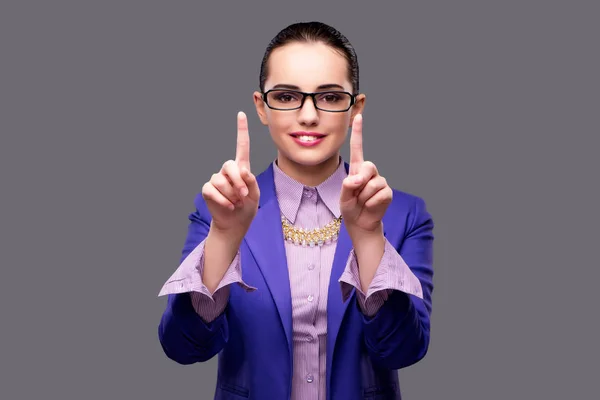 Businesswoman pressing virtual button on gray background — Stock Photo, Image