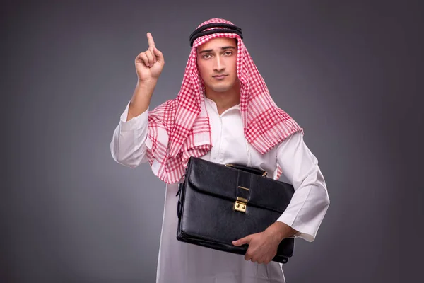 Arab businessman on gray background — Stock Photo, Image
