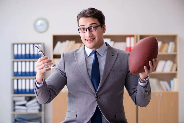 Empresario con fútbol americano en la oficina — Foto de Stock