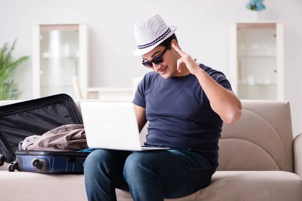 Man going on vacation packing his suitcase